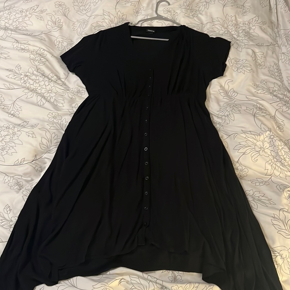 Black, shark bite dress. Can be partially unbuttoned at the top. Torrid size 2